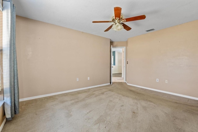 empty room with light colored carpet and ceiling fan