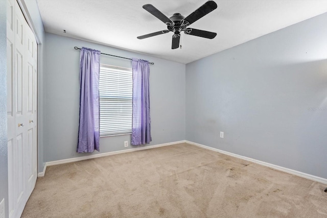 unfurnished room featuring light colored carpet and ceiling fan