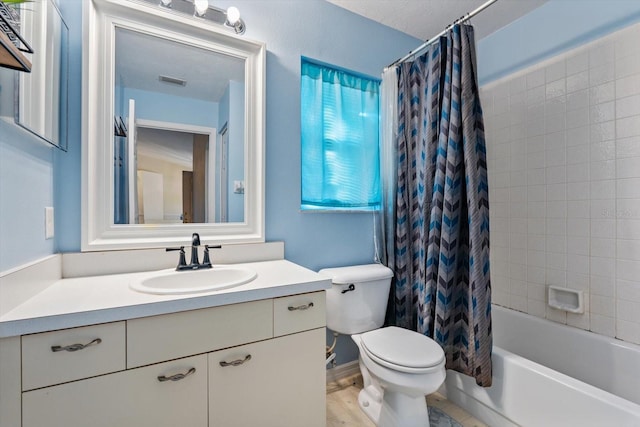 full bathroom featuring vanity, shower / bathtub combination with curtain, and toilet