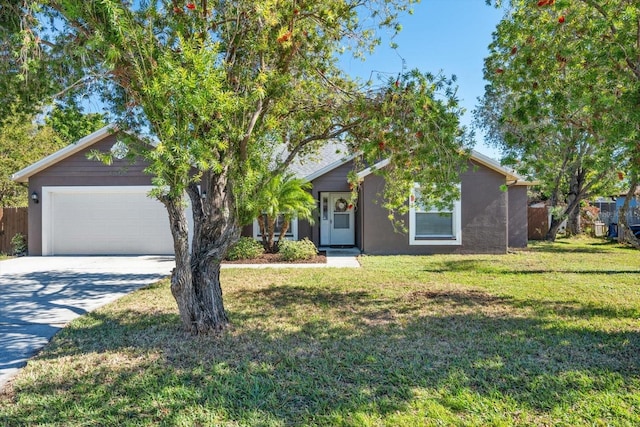 obstructed view of property featuring a front lawn and a garage