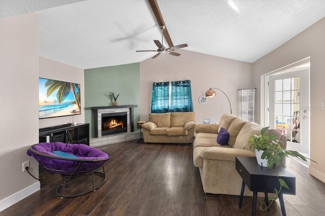 living room with a textured ceiling, dark hardwood / wood-style flooring, ceiling fan, and lofted ceiling