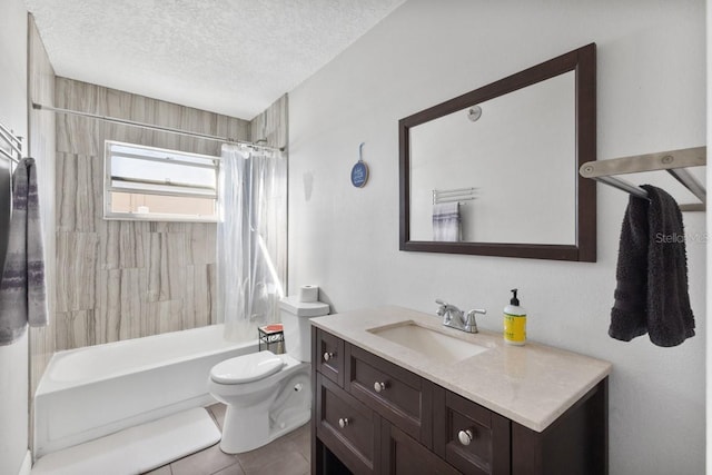 full bathroom featuring tile patterned floors, vanity, a textured ceiling, shower / bath combo with shower curtain, and toilet