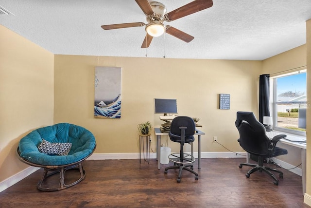 office area featuring ceiling fan, dark wood-type flooring, and a textured ceiling