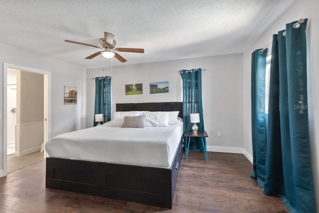 bedroom with ceiling fan, dark hardwood / wood-style floors, and a textured ceiling