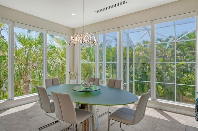 sunroom featuring plenty of natural light and an inviting chandelier