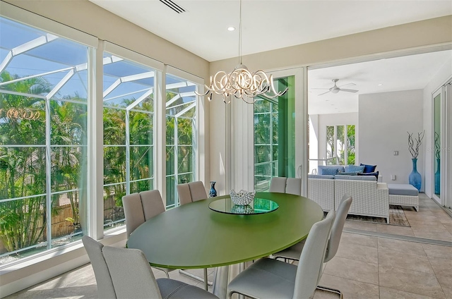 sunroom with a wealth of natural light and ceiling fan with notable chandelier