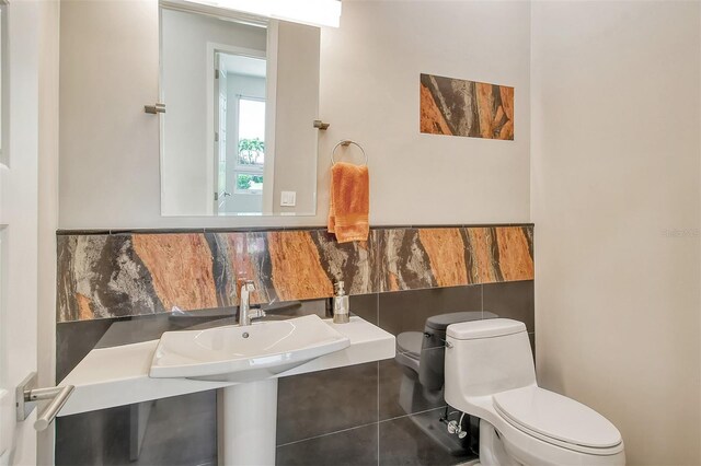 bathroom featuring tile patterned flooring, toilet, and sink