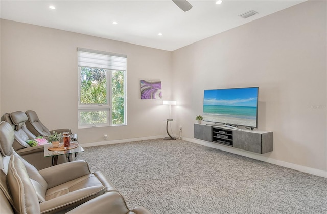 living area with carpet floors and ceiling fan