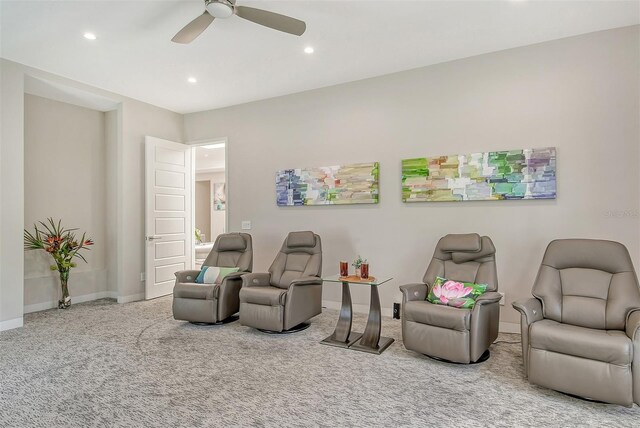 living area featuring ceiling fan and carpet floors