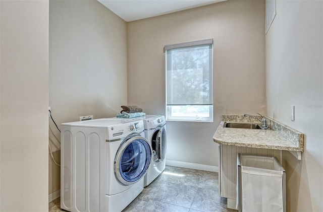 washroom featuring separate washer and dryer and sink