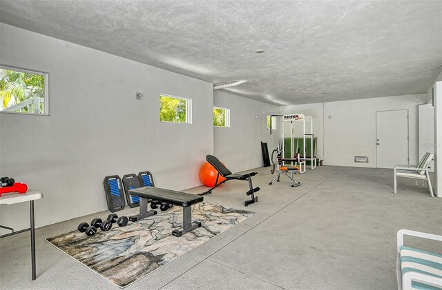 workout room with a wealth of natural light and a textured ceiling