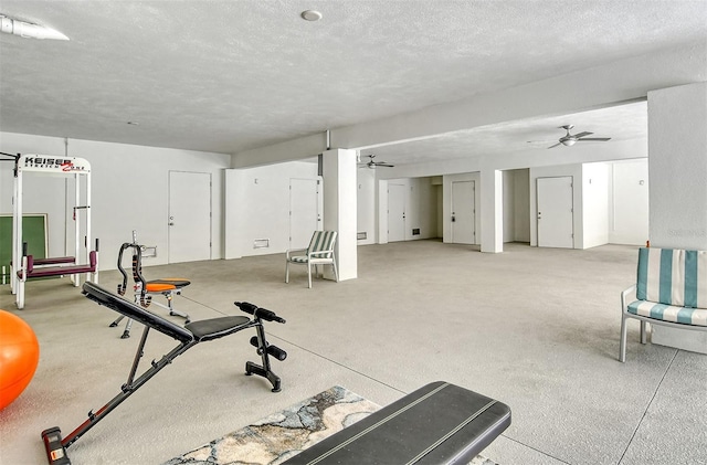 exercise area with a textured ceiling and ceiling fan