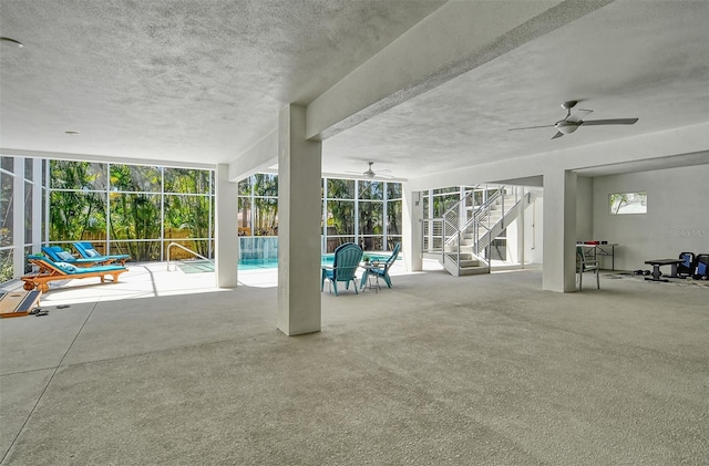 exterior space with ceiling fan and an indoor pool