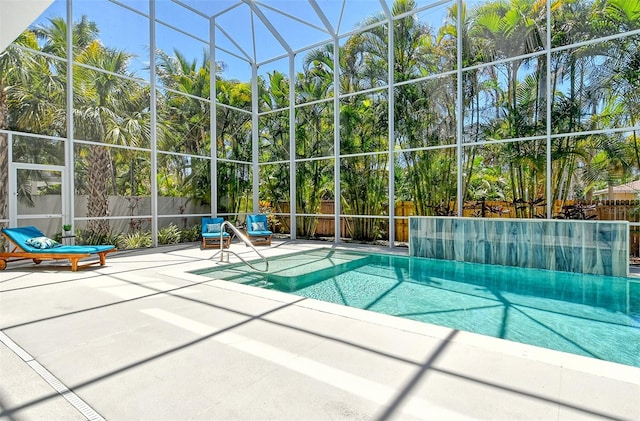 view of swimming pool with a patio and glass enclosure