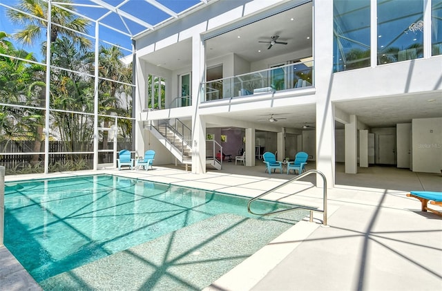 view of swimming pool featuring ceiling fan and a patio