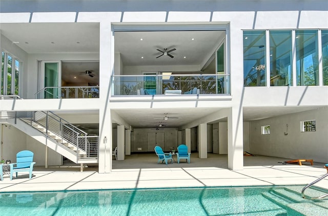 view of pool with a patio and ceiling fan