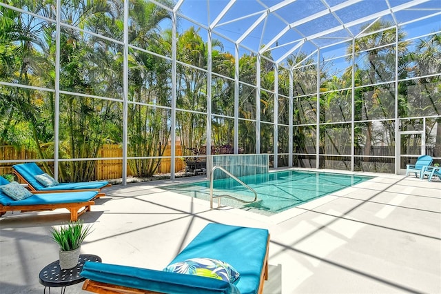 view of swimming pool with a lanai and a patio