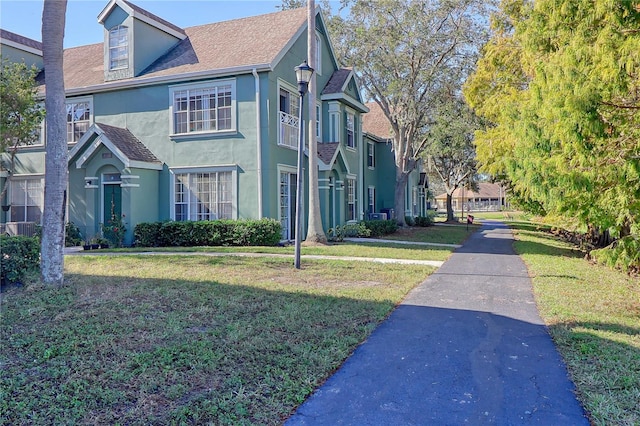 view of property exterior featuring a yard and central AC