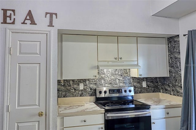 kitchen with decorative backsplash and stainless steel electric stove