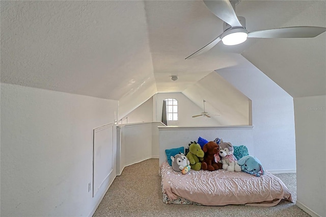 additional living space featuring ceiling fan, light colored carpet, lofted ceiling, and a textured ceiling