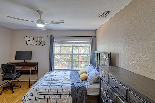 bedroom featuring light hardwood / wood-style flooring and ceiling fan