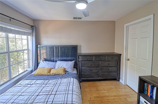 bedroom featuring multiple windows, ceiling fan, and light hardwood / wood-style floors