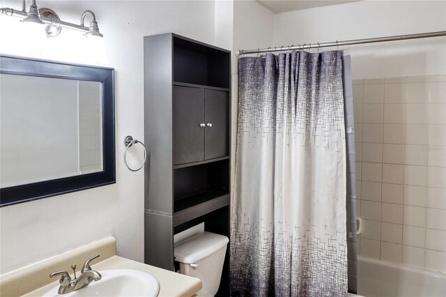 full bathroom with vanity, toilet, and shower / bath combo with shower curtain