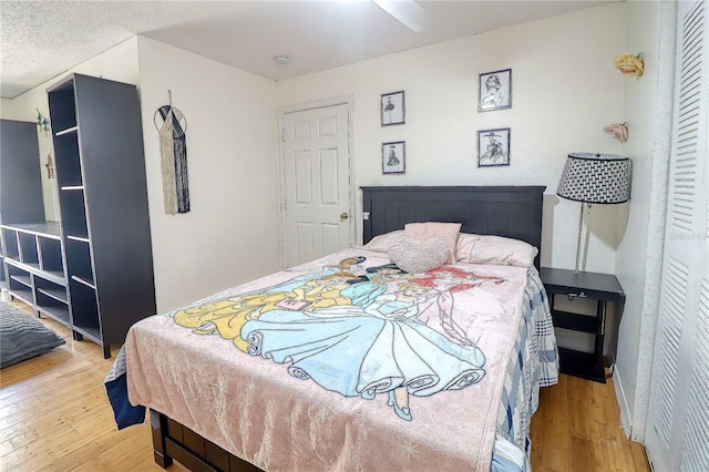 bedroom with ceiling fan and light hardwood / wood-style floors