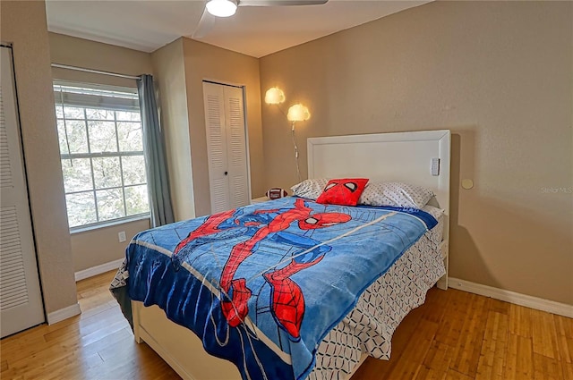 bedroom featuring hardwood / wood-style flooring, ceiling fan, and a closet