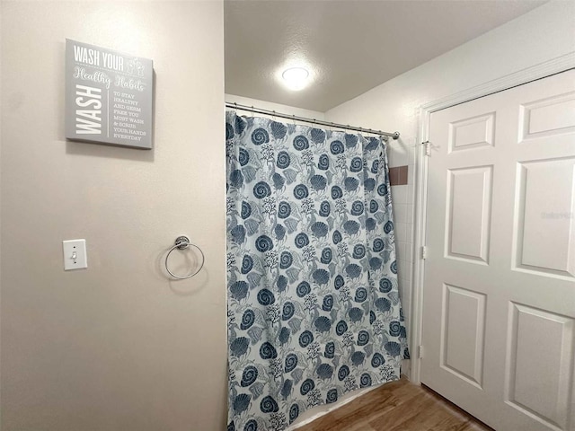 bathroom featuring hardwood / wood-style floors and curtained shower