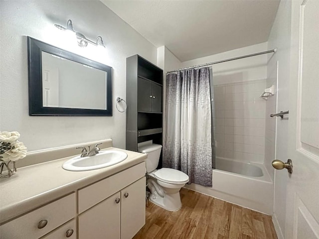 full bathroom with shower / bath combo with shower curtain, hardwood / wood-style floors, vanity, and toilet