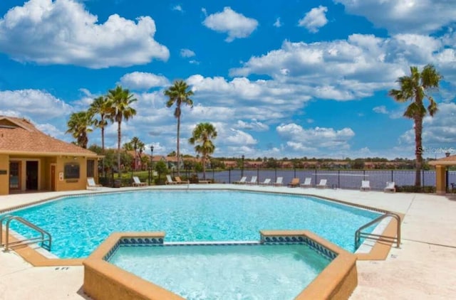 view of swimming pool with a community hot tub