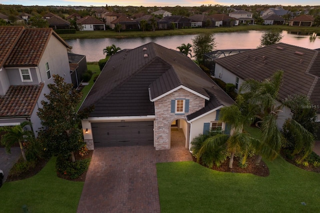 aerial view at dusk with a water view