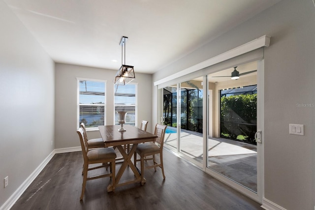 dining area with dark wood-type flooring, baseboards, and a ceiling fan