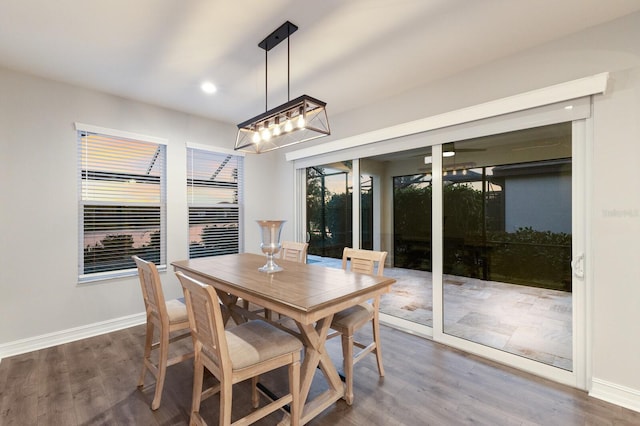 dining space featuring baseboards, dark wood-type flooring, and recessed lighting