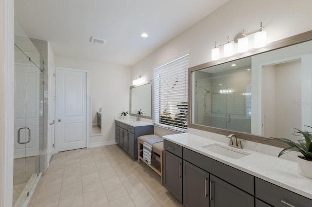 full bathroom featuring two vanities, a sink, visible vents, tile patterned floors, and a stall shower