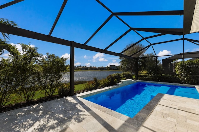 pool with a patio area, glass enclosure, and a water view