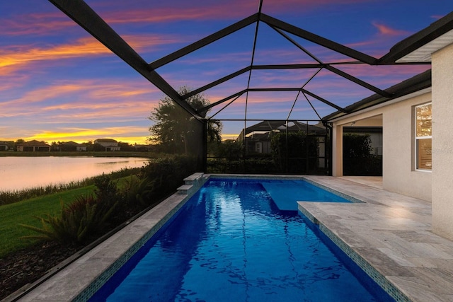 outdoor pool with a lanai, a water view, and a patio