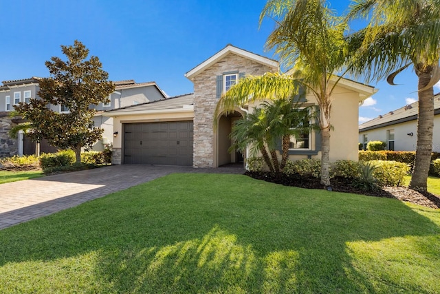 view of front facade featuring an attached garage, stone siding, a front lawn, and decorative driveway