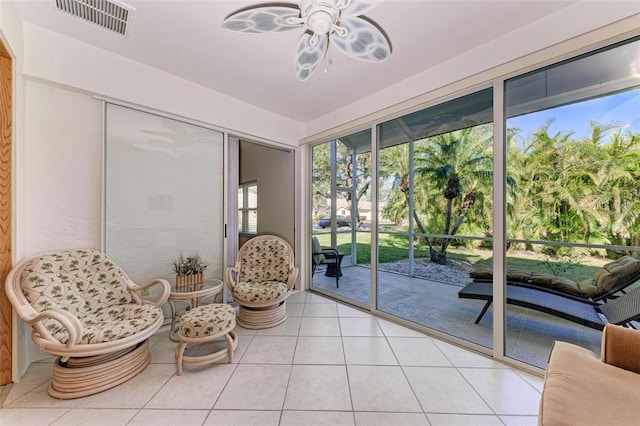 sitting room with ceiling fan and light tile patterned floors