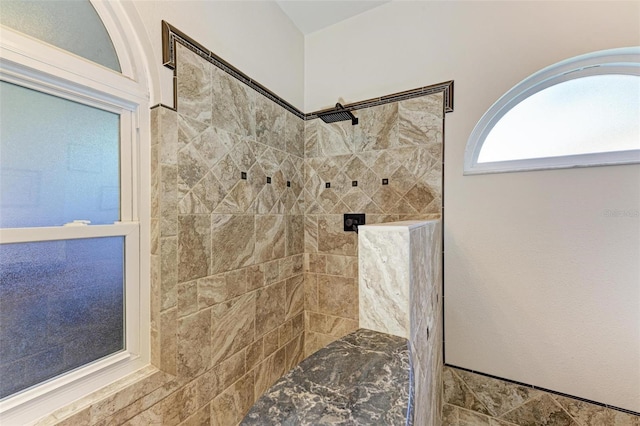 bathroom with a tile shower