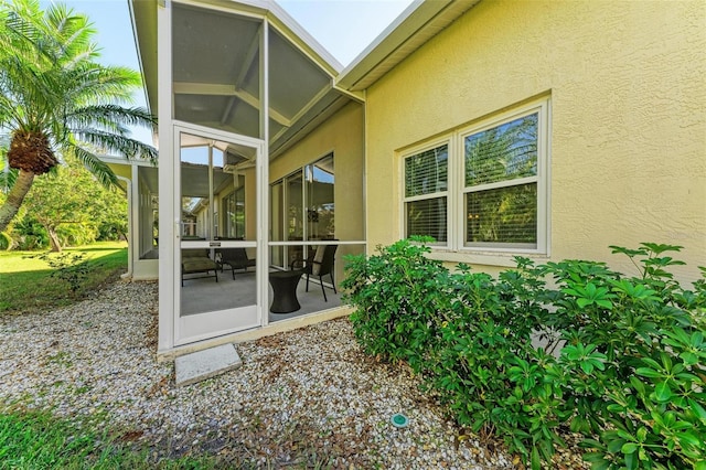 view of patio with a sunroom