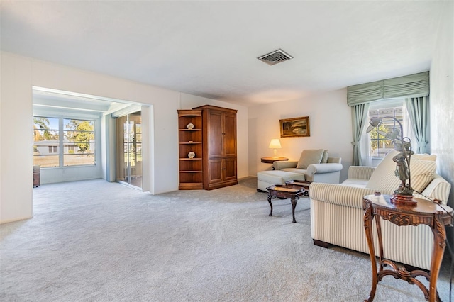 living room with plenty of natural light and light carpet