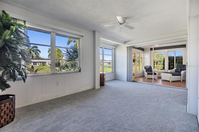 sunroom featuring ceiling fan and french doors