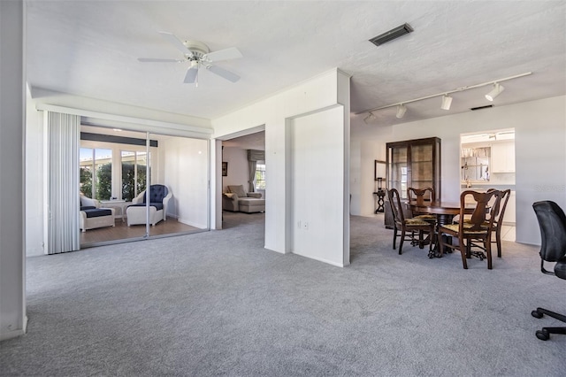 carpeted living room featuring ceiling fan