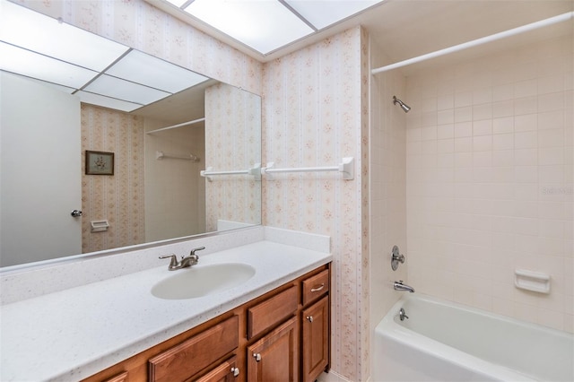 bathroom featuring vanity and tiled shower / bath combo