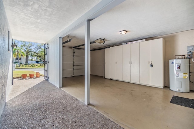 garage featuring electric water heater and a garage door opener