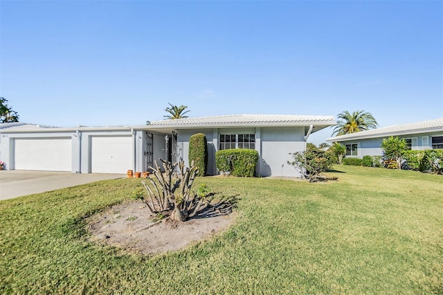 ranch-style home featuring a front yard and a garage