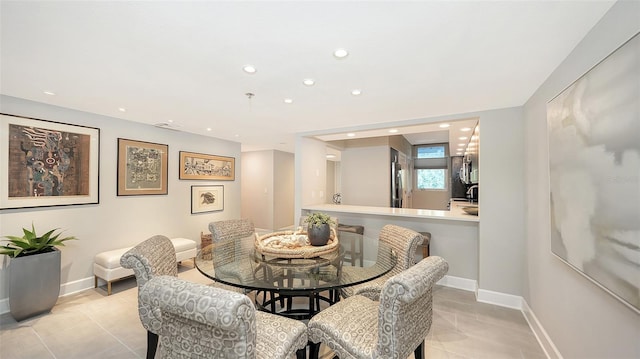 dining area with sink and light tile patterned flooring