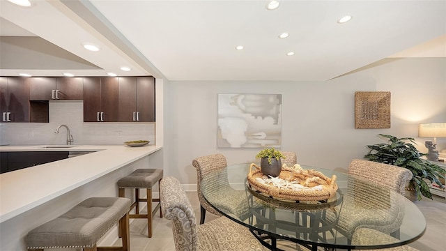 dining area featuring light tile patterned floors and sink